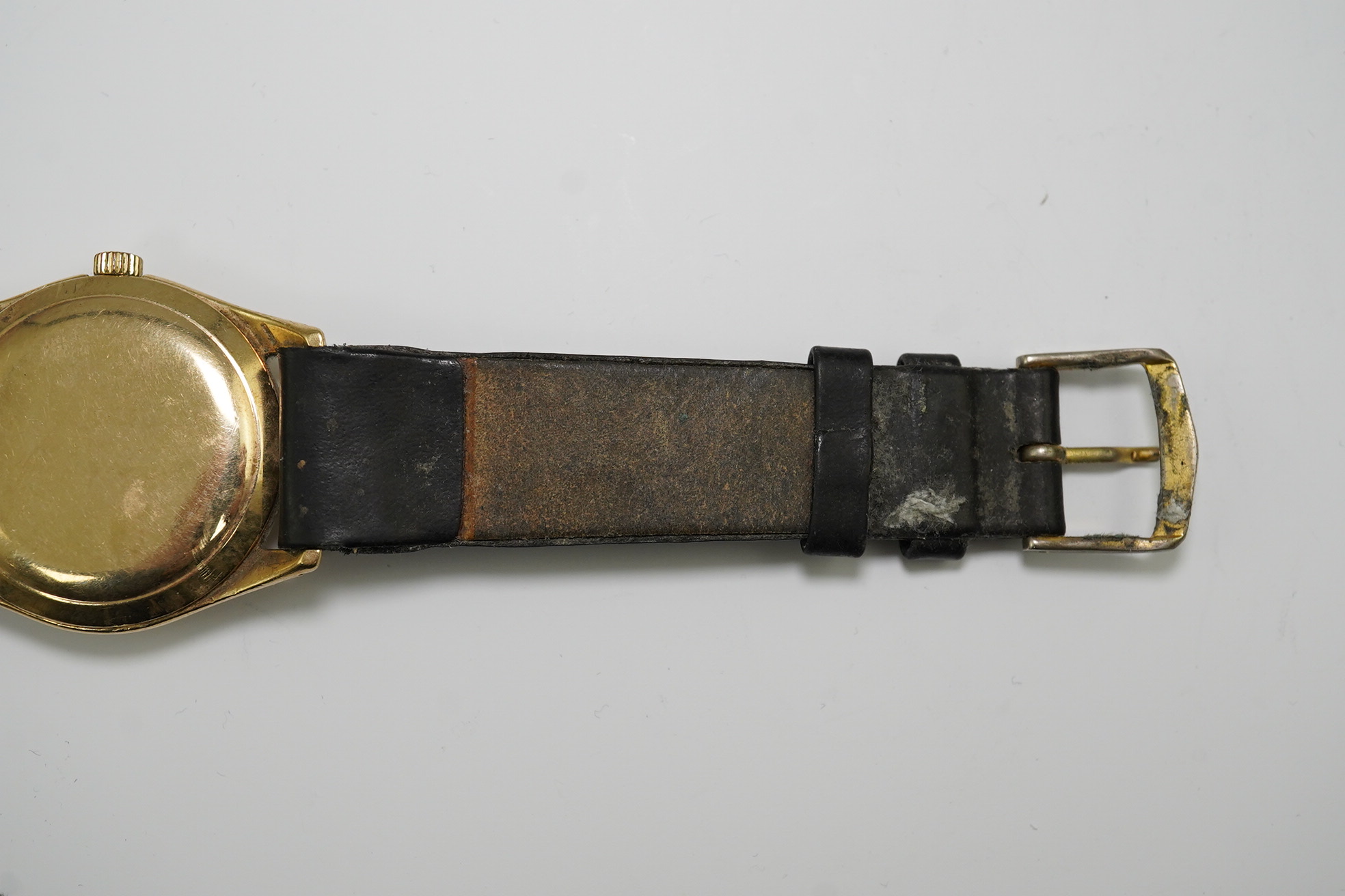 A gentleman's 1950's 9ct gold Omega manual wind wrist watch, with baton and Arabic numerals, movement c.420, case diameter 34mm, on associated leather strap. Condition- poor to fair